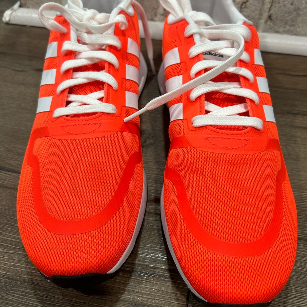 Neon orange adidas.  NWOT. Men’s 10.5